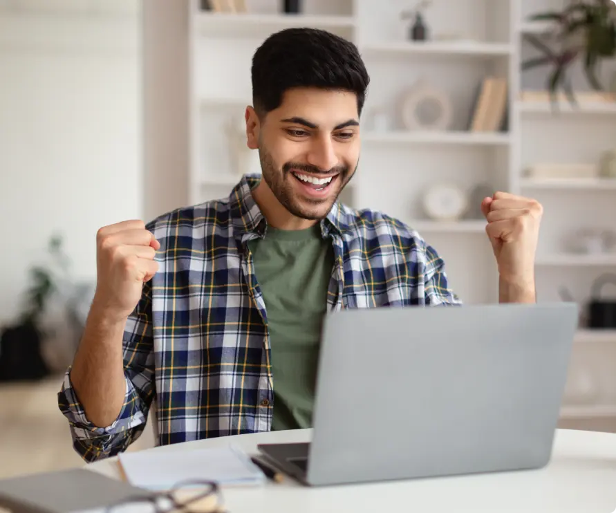 Man happily using his laptop